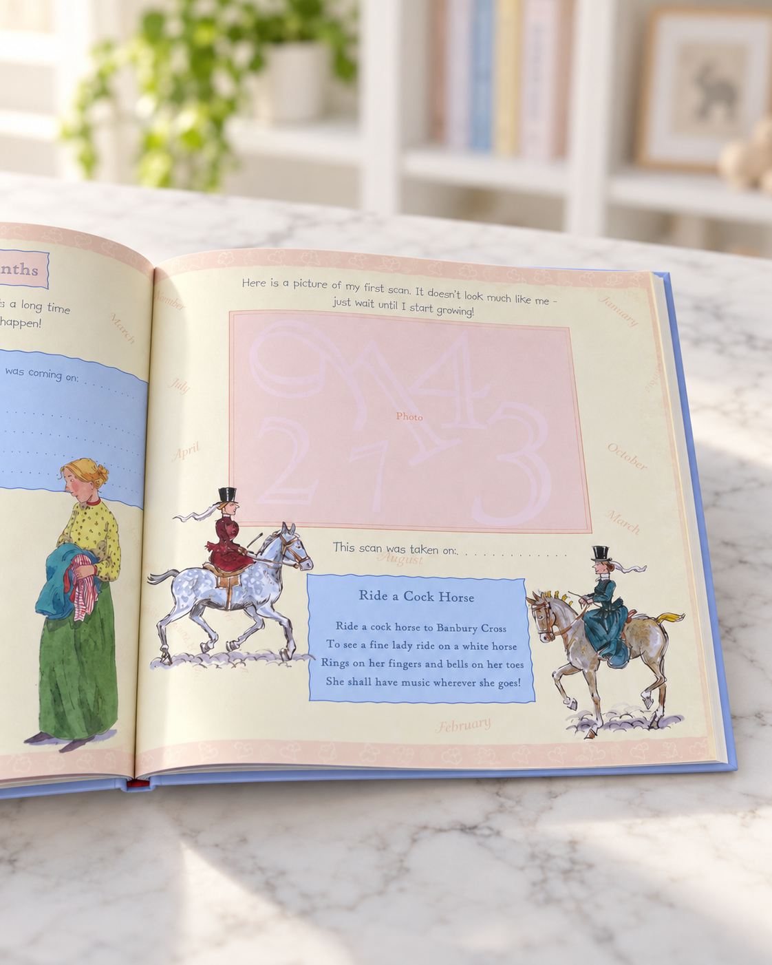 Baby Record Book, open book showing the Ride a Cock Horse page with a photo frame