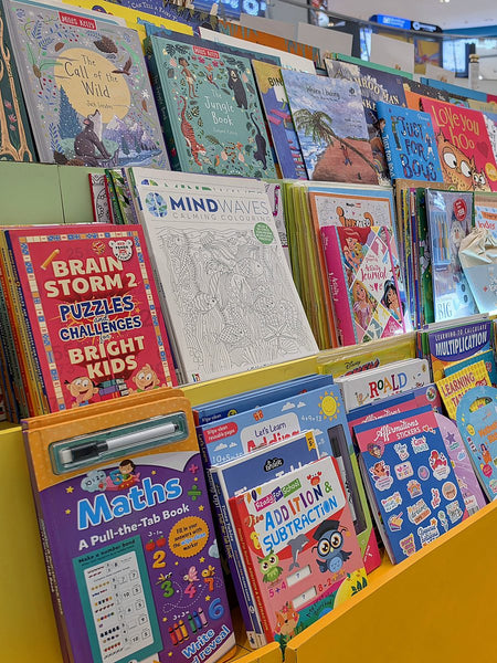 Children's activity, puzzle and colouring books on a curved display at Brain Chapters