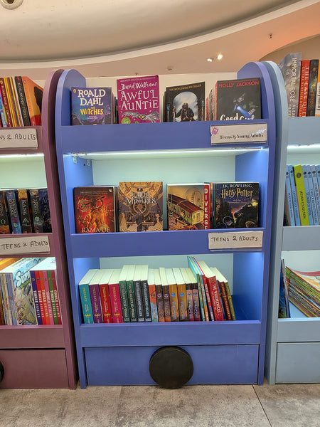 Blue bookshelf of books for teens at Brain Chapters