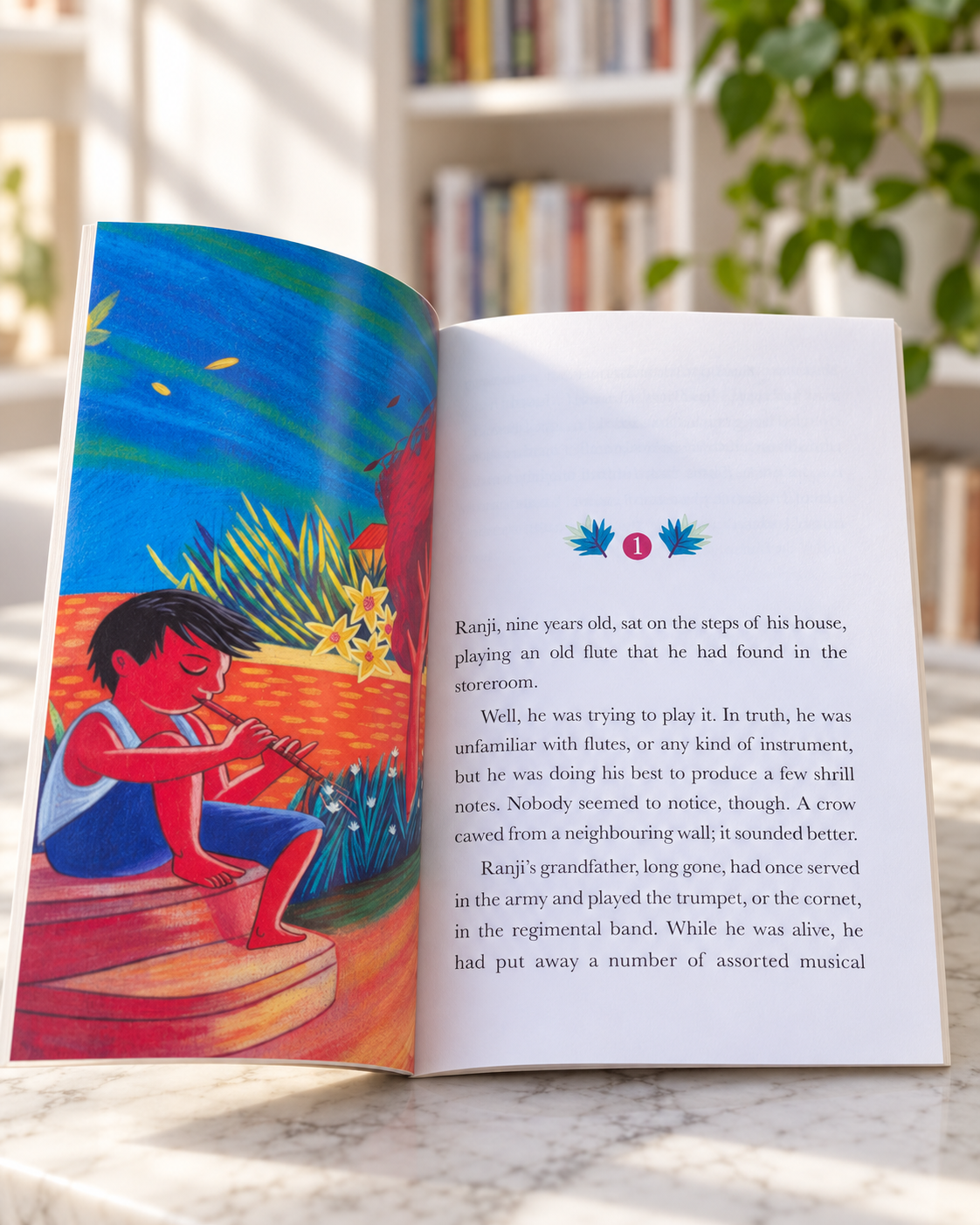 Ranji the Music Maker, open book showing a colourful illustration and the first chapter